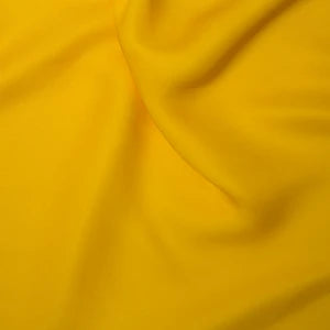 Yellow silky satin fabric sample 85gsm lightweight woven polyester with a fluid drape