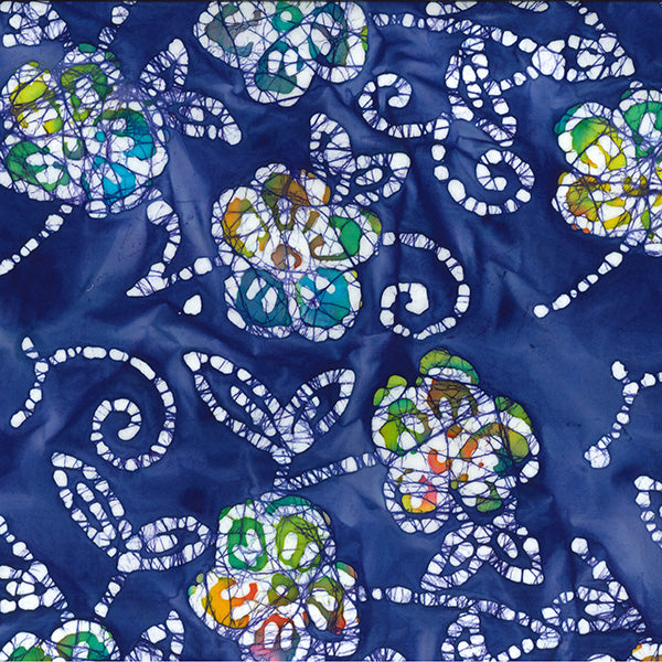 Navy 50s cotton batik fabric with white floral and swirl print with green and yellow accents