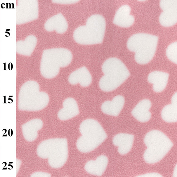 Pink fleece fabric with scattered white hearts and soft brushed texture