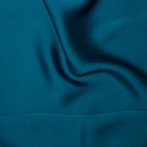 Teal silky satin fabric 85gsm lightweight woven polyester with a fluid drape
