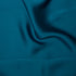 Teal silky satin fabric 85gsm lightweight woven polyester with a fluid drape